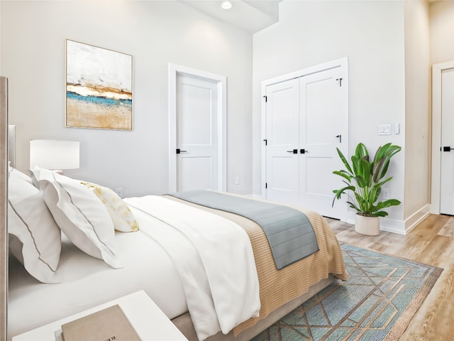 bedroom featuring a closet and light wood-type flooring