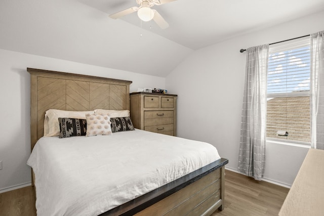 bedroom featuring ceiling fan, vaulted ceiling, and hardwood / wood-style floors