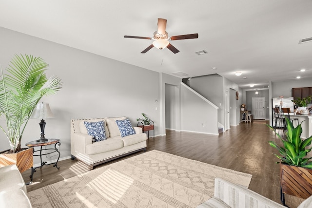 living room with ceiling fan and hardwood / wood-style floors