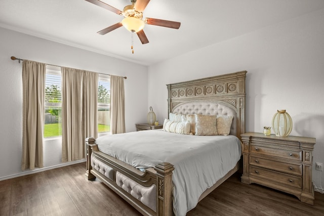 bedroom with ceiling fan and dark hardwood / wood-style floors