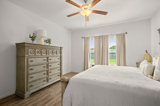 bedroom featuring hardwood / wood-style floors and ceiling fan