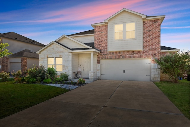 view of front of home with a yard and a garage