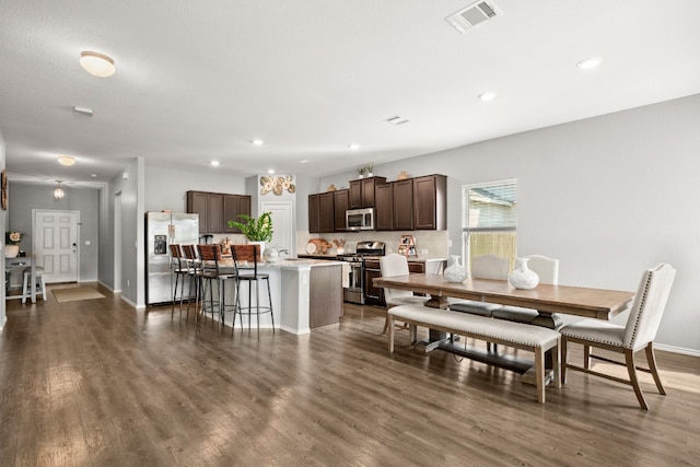 dining space featuring a chandelier and dark hardwood / wood-style flooring