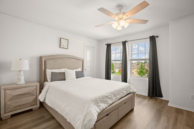 bedroom with wood-type flooring and ceiling fan