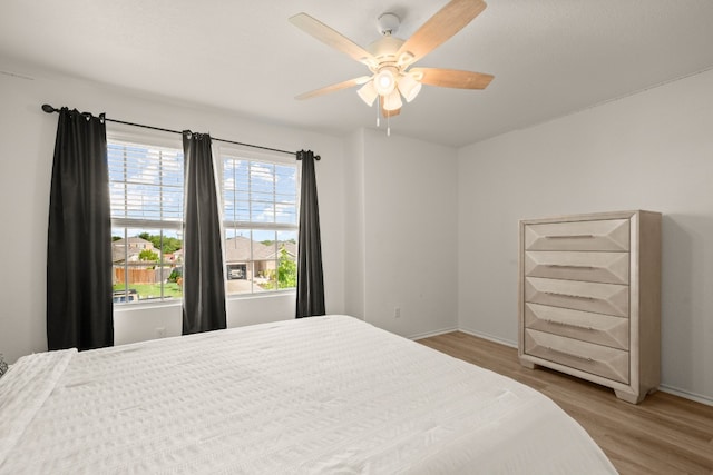 bedroom featuring light wood-type flooring and ceiling fan