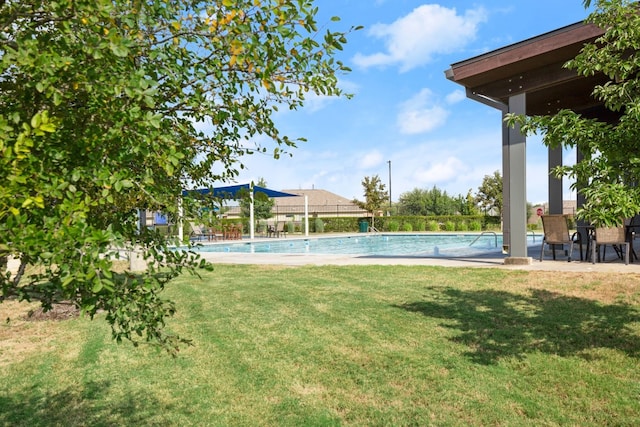 view of yard with a community pool and a patio