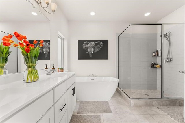 bathroom with tile patterned floors, vanity, and separate shower and tub