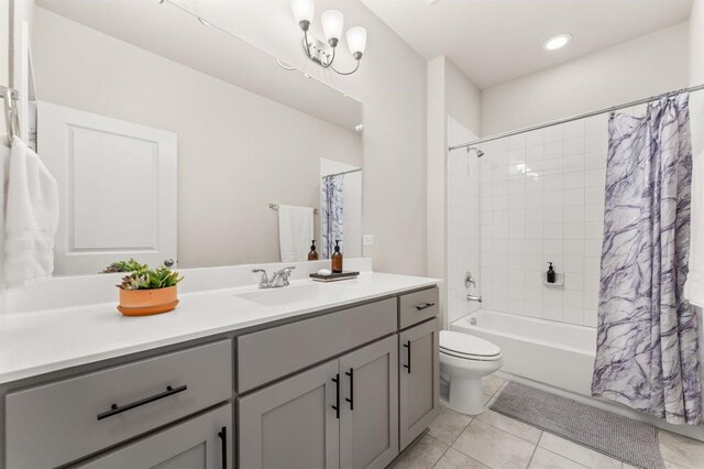 full bathroom with vanity, toilet, shower / bathtub combination with curtain, and tile patterned floors