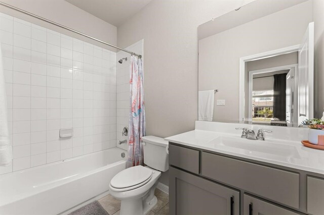 full bathroom featuring shower / tub combo with curtain, vanity, toilet, and tile patterned floors