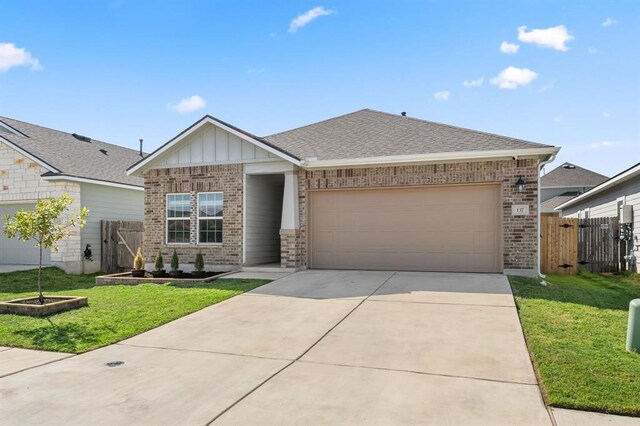 view of front facade with a garage and a front yard