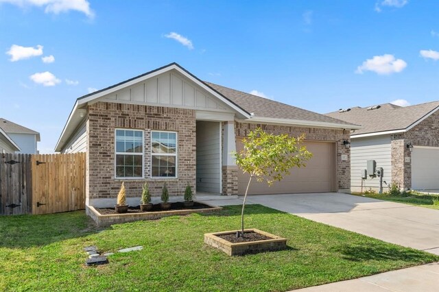 view of front of house with a front yard and a garage