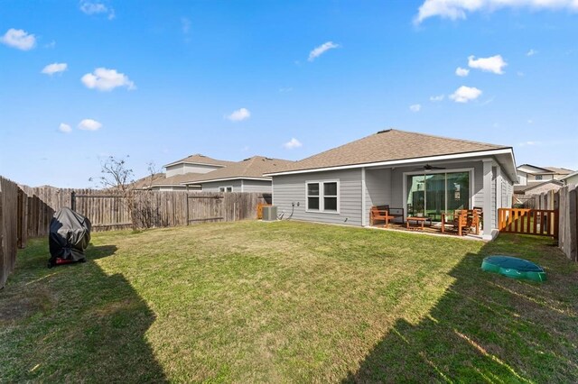 rear view of house with a yard and a patio