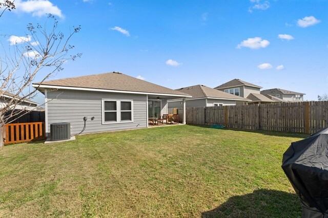 back of house with a patio, a yard, and central AC unit