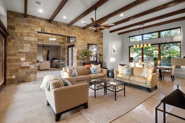 living room with beam ceiling, a towering ceiling, and ceiling fan