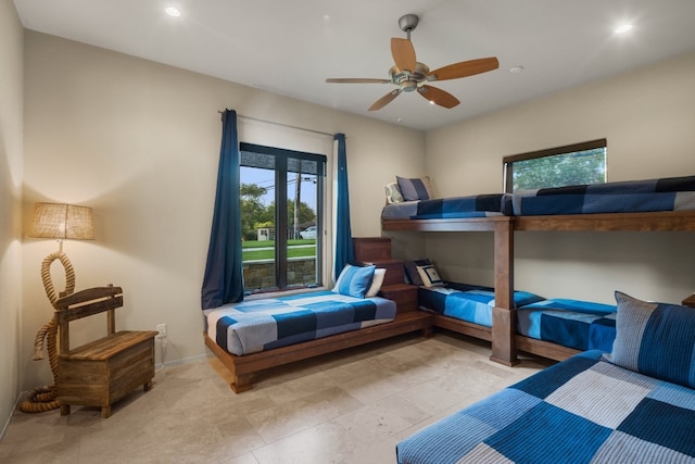 bedroom featuring ceiling fan and multiple windows