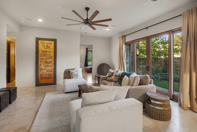 living room featuring ceiling fan and french doors