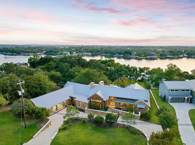 aerial view at dusk with a water view