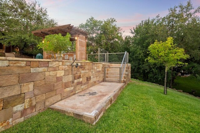 yard at dusk featuring a pergola