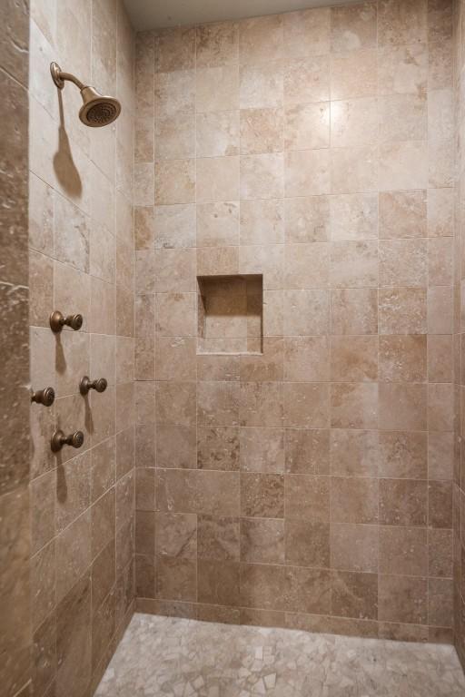 bathroom with a tile shower