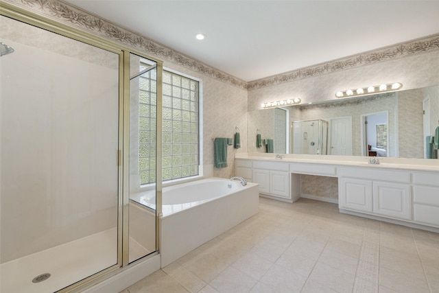 bathroom with vanity, tile patterned flooring, separate shower and tub, and a healthy amount of sunlight