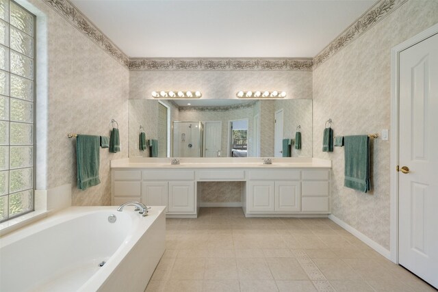 bathroom featuring tile patterned flooring, independent shower and bath, plenty of natural light, and vanity