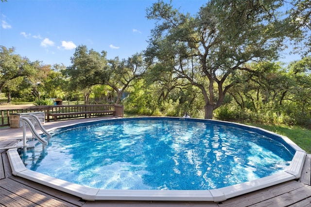 view of swimming pool with a wooden deck