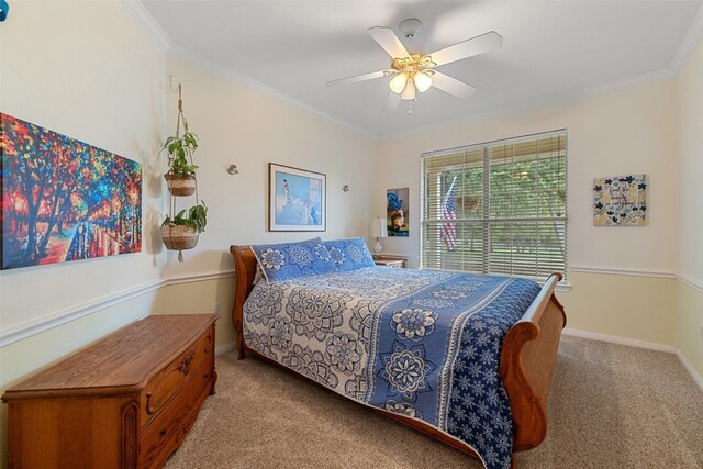 carpeted bedroom featuring crown molding and ceiling fan