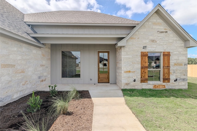 entrance to property with a lawn