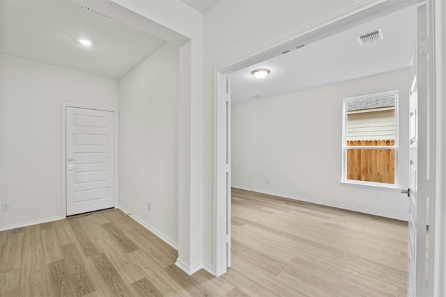 hallway with light hardwood / wood-style flooring