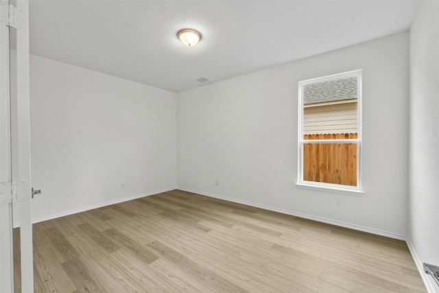 1721 Tin Can Trl, Georgetown, TX 78628 - spare room featuring light wood-type flooring and baseboards