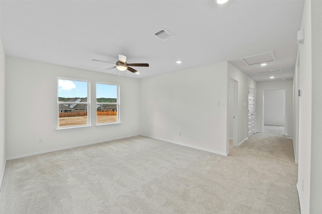 spare room with light carpet and ceiling fan