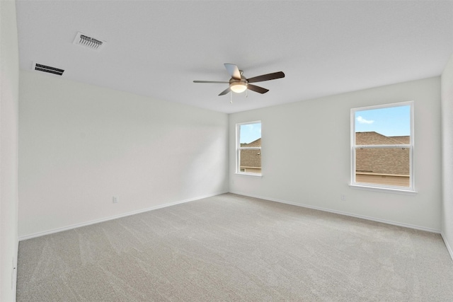 empty room featuring light colored carpet and ceiling fan