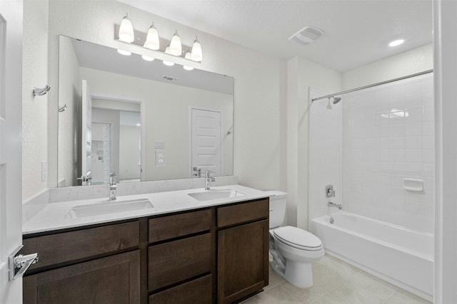 full bathroom featuring a textured ceiling, toilet, vanity, tile patterned floors, and tub / shower combination