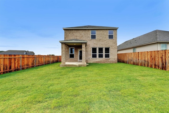 back of house featuring a yard