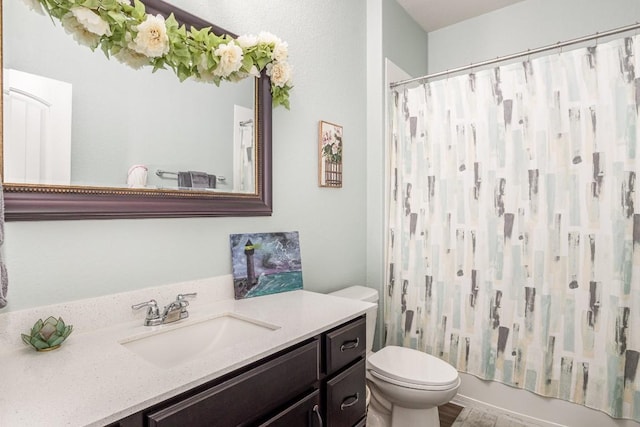 bathroom featuring toilet, shower / tub combo with curtain, and vanity