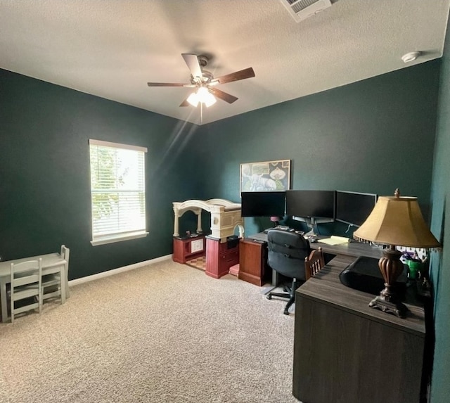 office space featuring carpet flooring, a textured ceiling, and ceiling fan