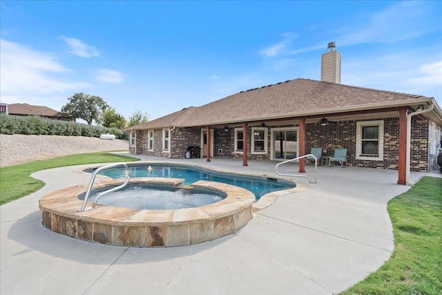 view of swimming pool with an in ground hot tub, ceiling fan, and a patio area