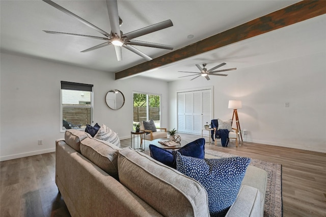 living room with beamed ceiling, wood-type flooring, and ceiling fan