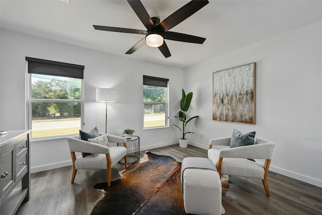 sitting room with hardwood / wood-style floors, a wealth of natural light, and ceiling fan