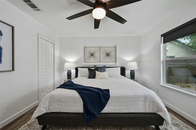 bedroom featuring a closet, ceiling fan, and dark hardwood / wood-style floors