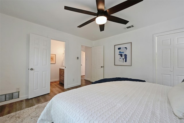 bedroom featuring hardwood / wood-style floors, ceiling fan, and ensuite bath