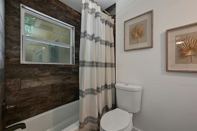 bathroom with shower / tub combo with curtain and toilet