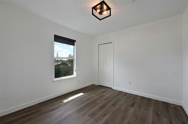 spare room with dark hardwood / wood-style flooring