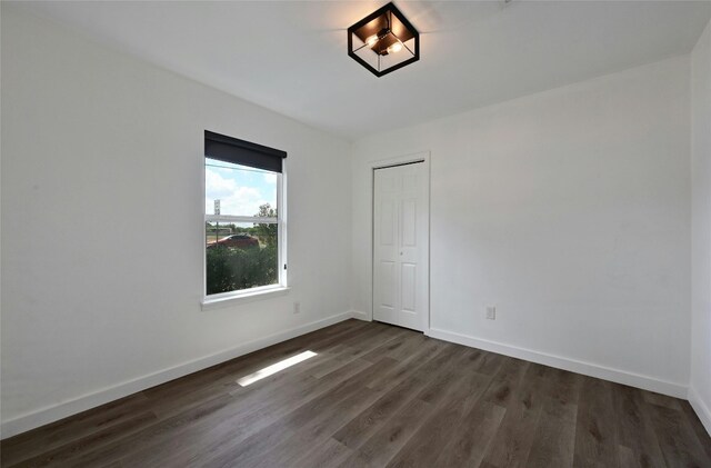 1130 Gardner Rd, Austin, TX 78721 - spare room with dark wood finished floors and baseboards