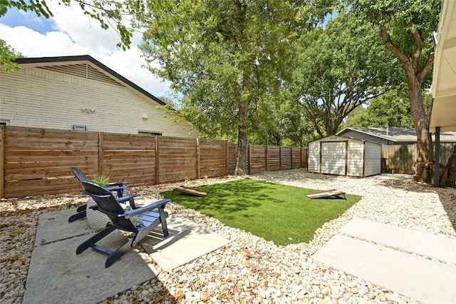 view of yard with a patio area and a storage shed