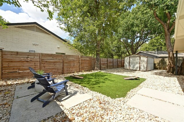 1130 Gardner Rd, Austin, TX 78721 - fenced backyard featuring a patio and a storage unit