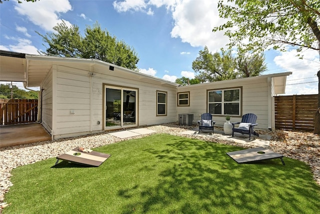 rear view of property featuring a yard and a patio area