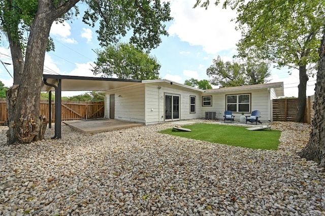 rear view of property featuring cooling unit and a patio