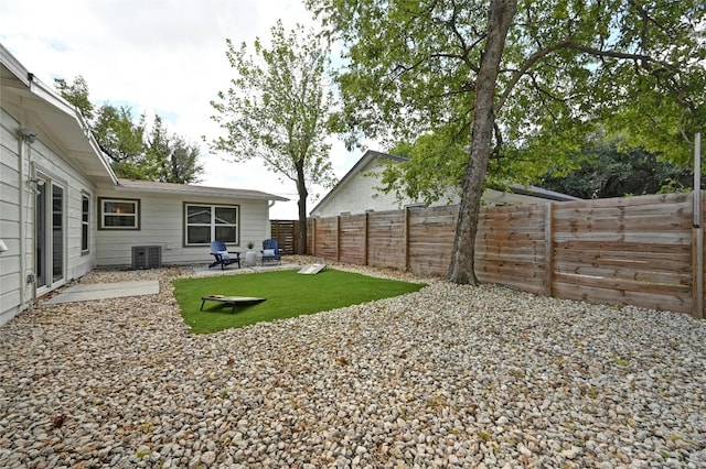 view of yard featuring central AC unit and a patio