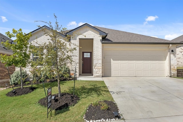 view of front of property with a front yard and a garage